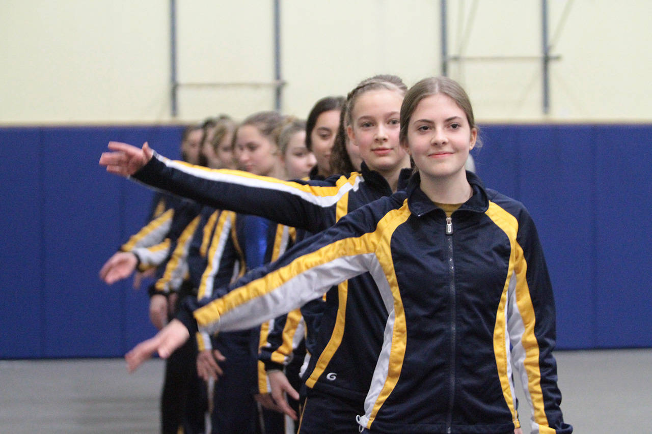 The Spartans give a group wave to the crowd at this years opening meet. (Brian Kelly | Bainbridge Island Review)