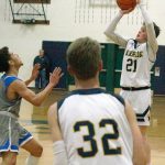 Luciano Marano | Bainbridge Island Review - Bainbridge High School sophomore Alexander Taylor attempts a three-pointer during last Fridays home game against Ingraham.                                 Luciano Marano | Bainbridge Island Review - Spartan sophomore James Carey attempts to work around an Ingraham defender near the net during last Fridays home game.
