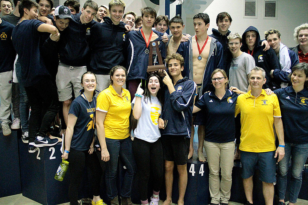 The Bainbridge Spartans hoist the second-place team trophy. (Brian Kelly | Bainbridge Island Review)