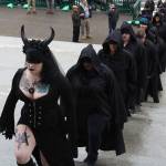 Angel, who goes by one name and is the ritual guild leader for the Satanic Temple of Washington State, leads the procession up the capitol steps as part of their ritual. (Cameron Sheppard | WNPA News Service)