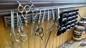 Luciano Marano | Bainbridge Island Review - Stilled scissors hang at Sandys Barber Shop in downtown Winslow, one of several island barbers, beauty parlors and salons to report noticeably less customers even before Gov. Jay Inslees Monday decree all such businesses must close to curb the spread of COVID-19.