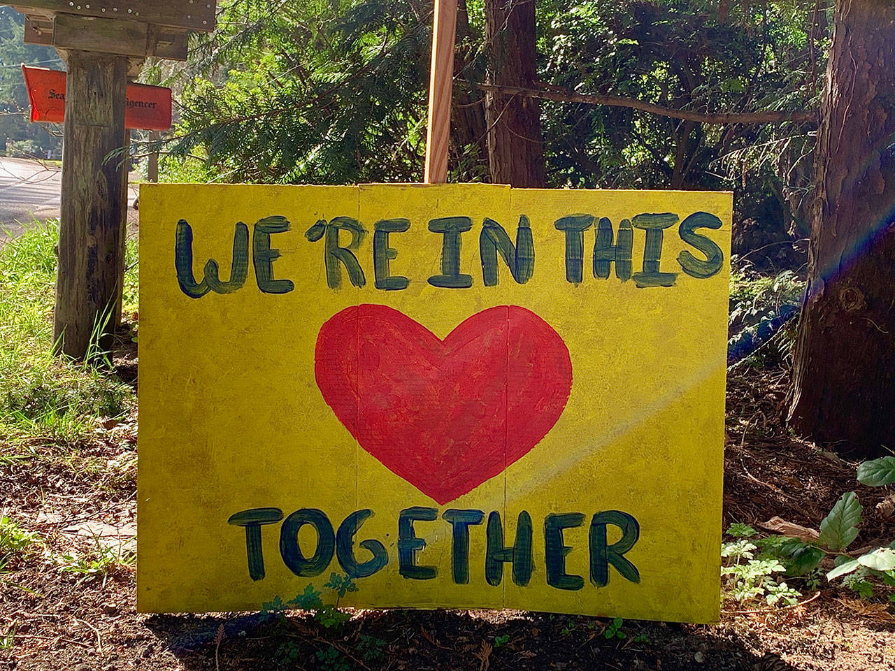 A sign posted by a Bainbridge Island resident on Pleasant Beach Drive NE. The Bainbridge Island Historical Museum has started to collect photographs and other items from residents to document the COVID-19 crisis on the island. (Photo courtesy of the Bainbridge Island Historical Museum)