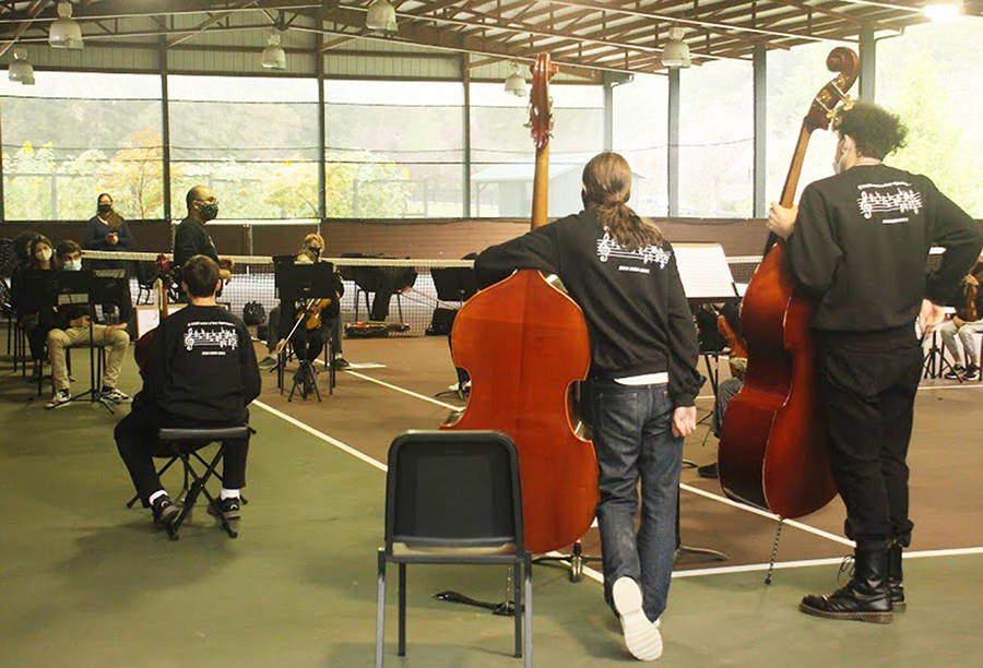 Orchestra members listen as conductor Tigran Arakelyan gives instructions.