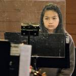 Musicians who play brass or woodwinds without masks perform behind plastic shields.