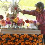 Patch owner Karen Selvar arranges flowers at one of the checkout stands.