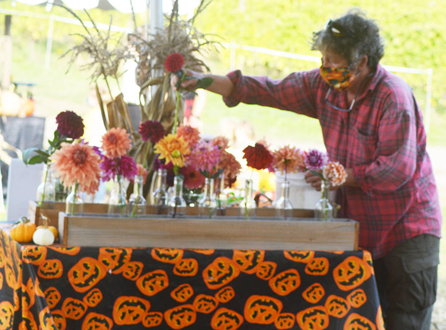 Patch owner Karen Selvar arranges flowers at one of the checkout stands.