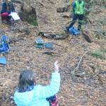 A student asks a question as they take a break while on a hike.