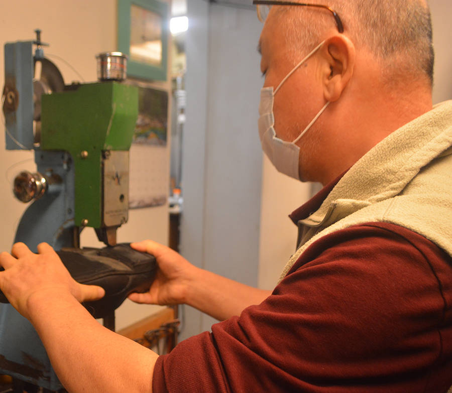 Chum Cho works on the heel of a shoe.