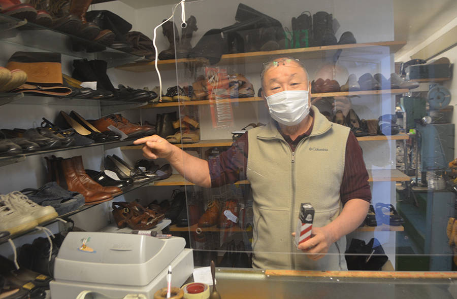 Chum Cho welcomes customers behind a plexiglass shield during COVID-19.