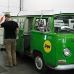 EV Works technicians take a look at Joule, the shop's electric Volkswagen bus. (Mark Krulish/Kitsap News Group)