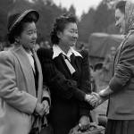 Ritsuko and Toshiko Terayama say goodbye to a friend at the ferry dock. Museum of History and Industry/Seattle PI Collection