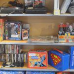 Rock Band and superhero items are in this display.