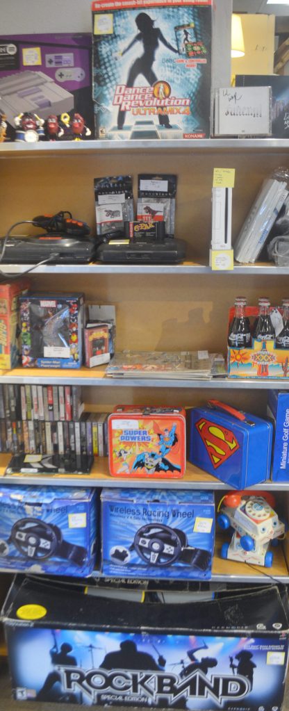 Rock Band and superhero items are in this display.