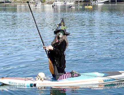 A witch is seen on a paddleboard in Eagle Harbor. Dinah Satterwhite/Courtesy photo