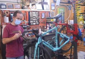 Owner Paul Johnson repairs a bicycle at Classic Cycle on Winslow Way. Steve Powell/Bainbridge Island Review photographs
