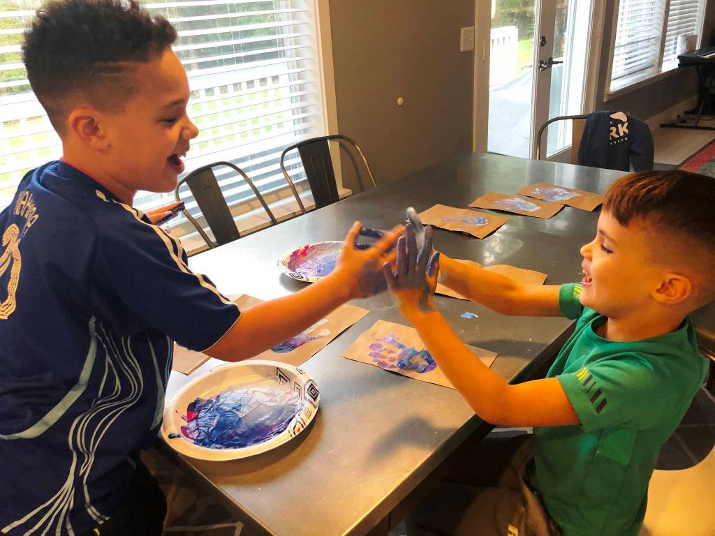 Enzo and Teo Malatesta have a lot of fun with paint making cards for the event. Courtesy photo