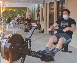Clients work on on rowing machines outside under canopies. Steve Powell/Bainbridge Island Review photos