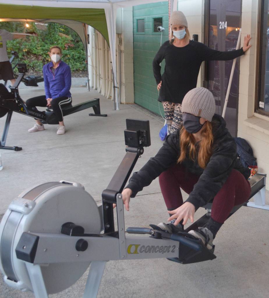 Bethanee Randles shows clients how to use all their leg muscles and not just their arms when using the rowing machine.