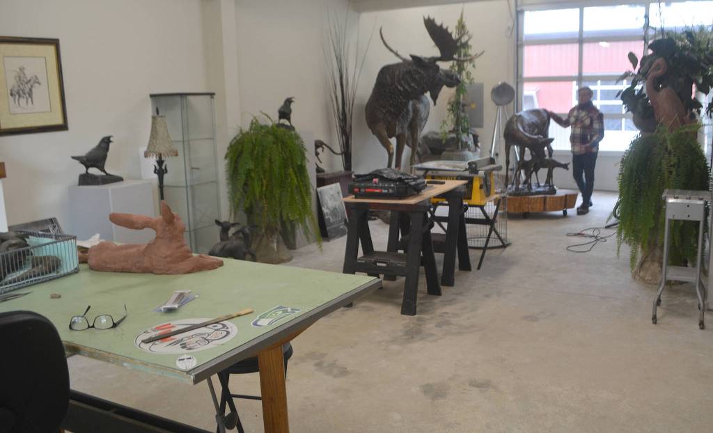 Above: The studio where Jeff Oens does his artwork. Right: A jockey rides a horse in a race. Bottom right: Three chum salmon are a part of this piece. Below: The finished clay process of Jeff Oens famous Eli Creekmore statue.