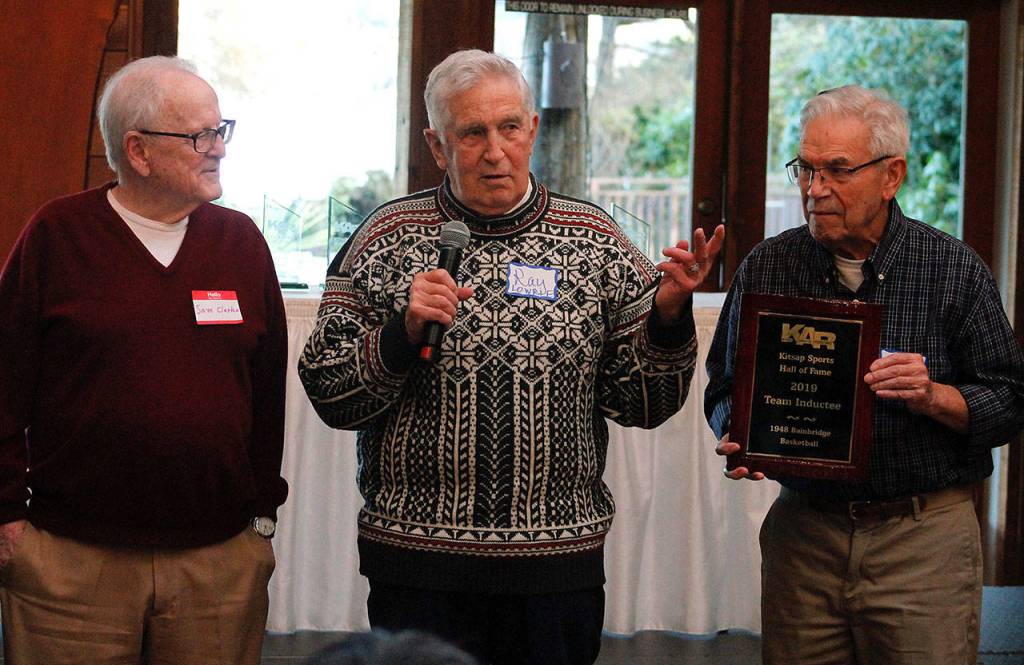 Sam Clarke, Ray Lowrie and Jim Nadeau hold up the 1948 state championship teams commemorative plaque.