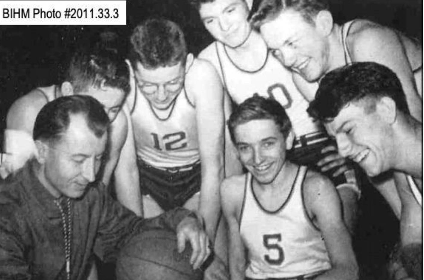 Bainbridge head coach Tom Paski shares the trophy with some of his players, including Bob Sigle (5), Pete Uglesich (10) and Bob Woodman (12). (Photo courtesy Bainbridge Island Historical Museum)
