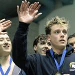 The Spartan state championship 200-yard freestyle relay team waves to the crowd from the winners platform. From left, Jude Wenker, Andrew Witty, Harrison Villella, and Tyler Stewart. (Review file photo)