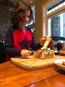 Stefan Flemetakis, 10, gets into the holiday spirit with classmates at The Island School. The last day before winter break marks a decades-long tradition at the school when students make gingerbread houses. Here, Stefan adds more frosting (snow) to his roof. But they dont stop there. Etta Henry made a castle and Naomi Baker even made a vehicle from Star Wars, complete with a light-saber wielding Jedi gummy bear. 	 <em>Courtesy photo</em>