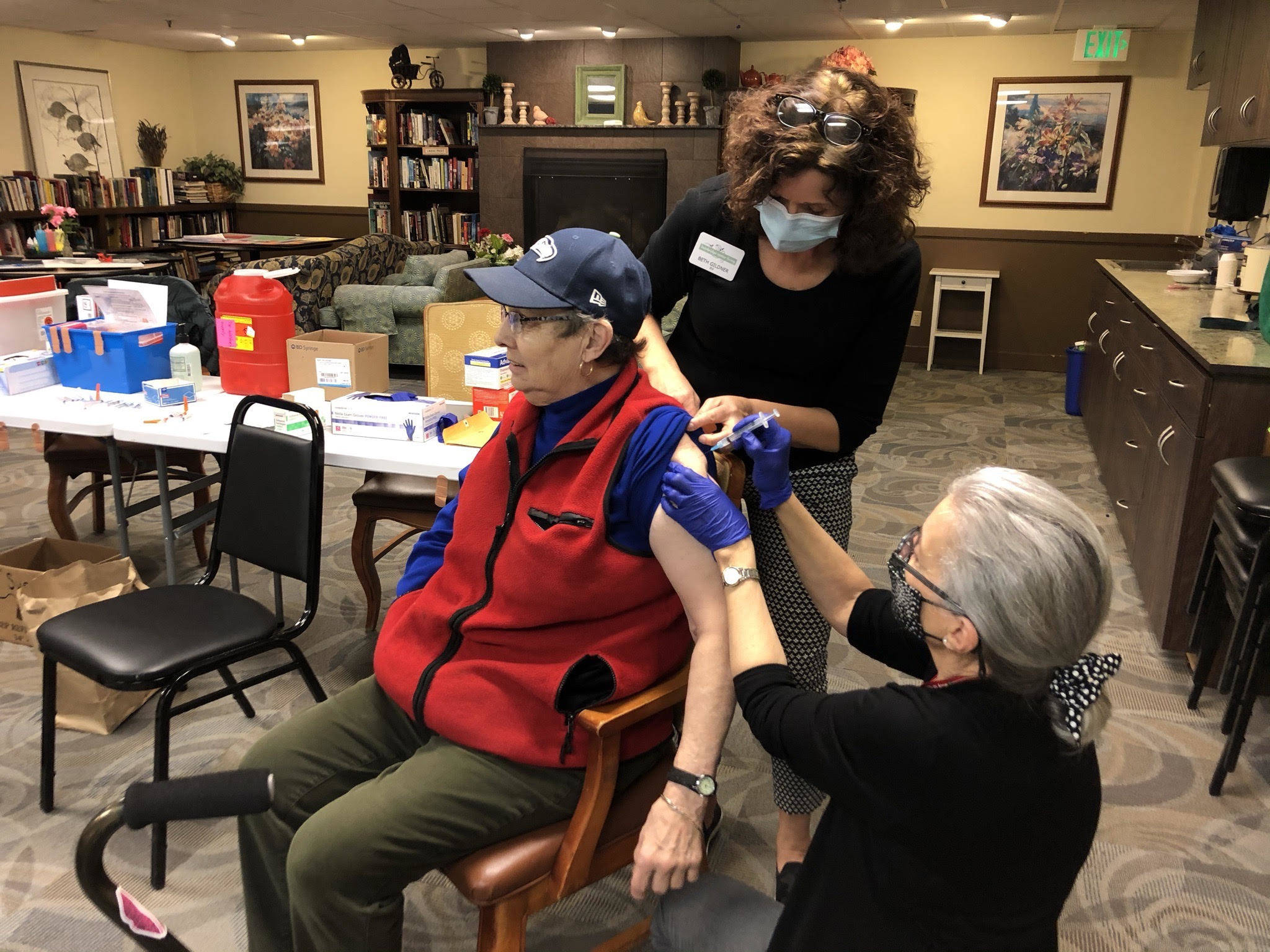 Courtesy photo
Sue Pomar at Madison House receives the vaccine from staff nurse Beth and Shannon Fitzgerald.
