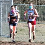 Bainbridges Eden Michael (left) and South Kitsaps Evelyn Collins-Winn lead the pack during the first Olympic League meet of the season at North Mason High School. (Mark Krulish/Kitsap News Group)