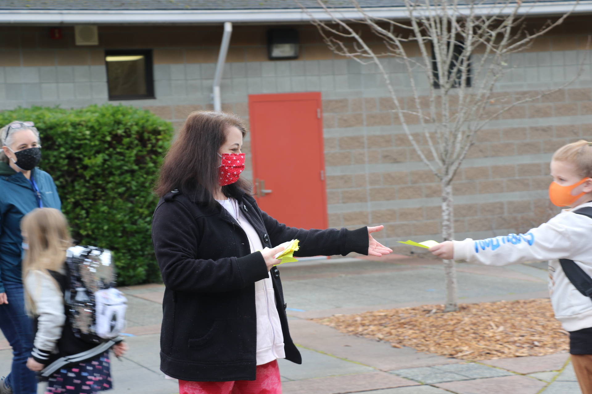 A Vinland staff member collects attestation slips from students.