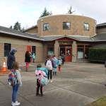 Yellow feet markers are used as space reminders for students to stay 6 feet apart while in line.