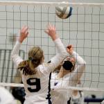 North Kitsap hitter Lillian Pruden battles at the net with Bainbridges Lauren de Gall (9). (Mark Krulish/Kitsap News Group)
