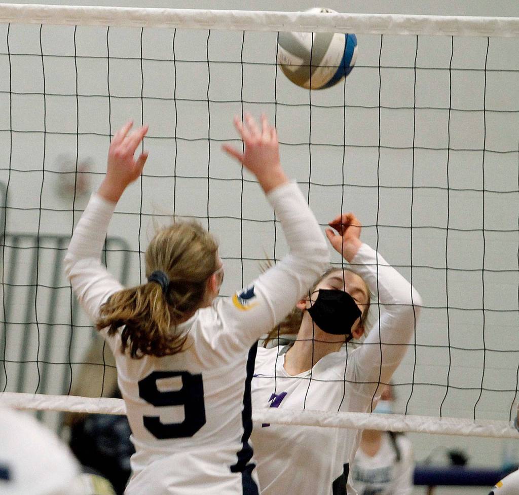 North Kitsap hitter Lillian Pruden battles at the net with Bainbridges Lauren de Gall (9). (Mark Krulish/Kitsap News Group)