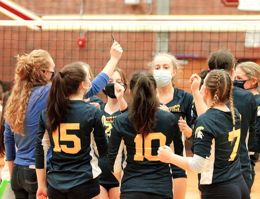 The Spartans gather to celebrate their three-set victory over South Kitsap. (Mark Krulish/Kitsap News Group)