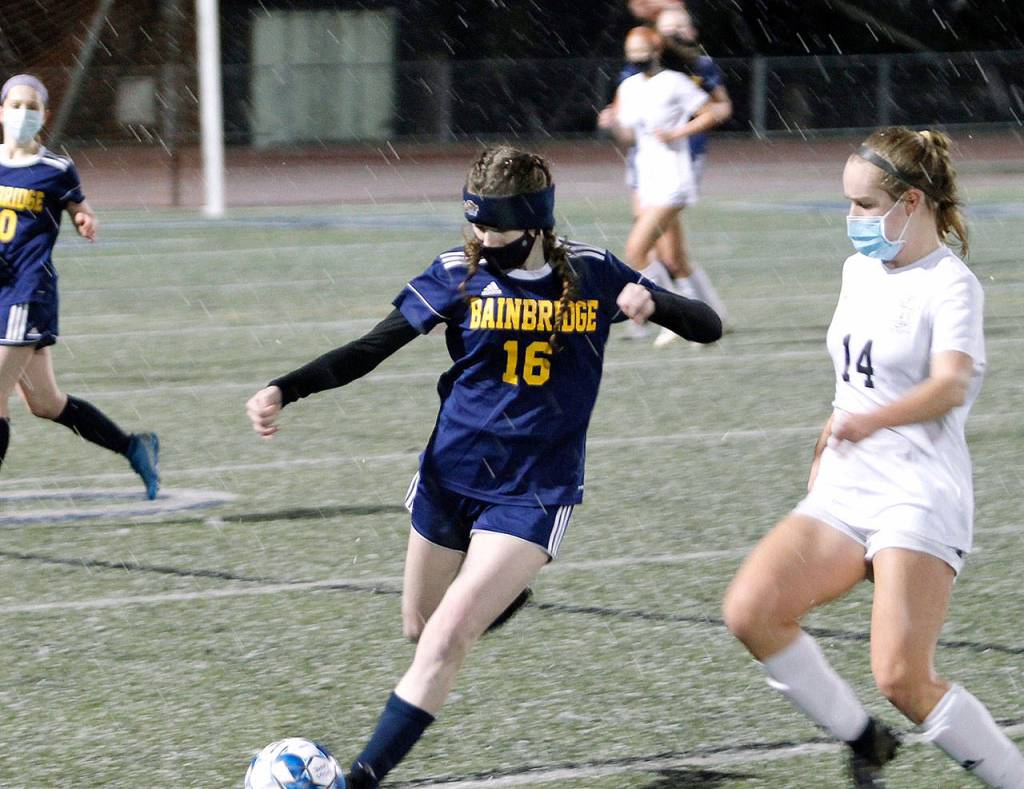 Erin Weiss (16) clears the ball away from Ella Smith (14) against Central Kitsap.