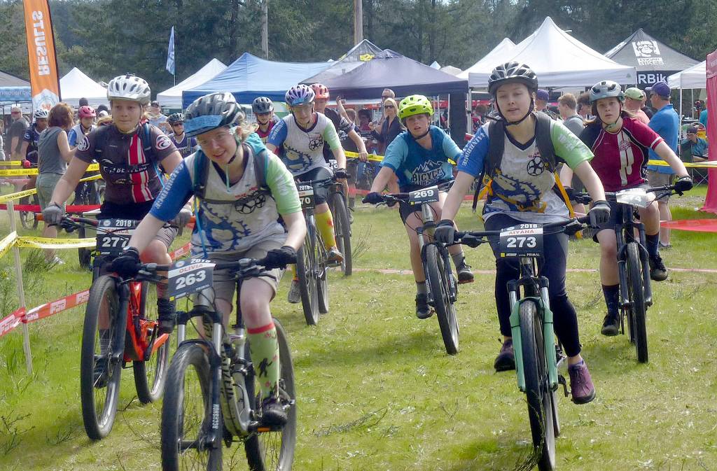 Mountain bikers go through a skills clinic.