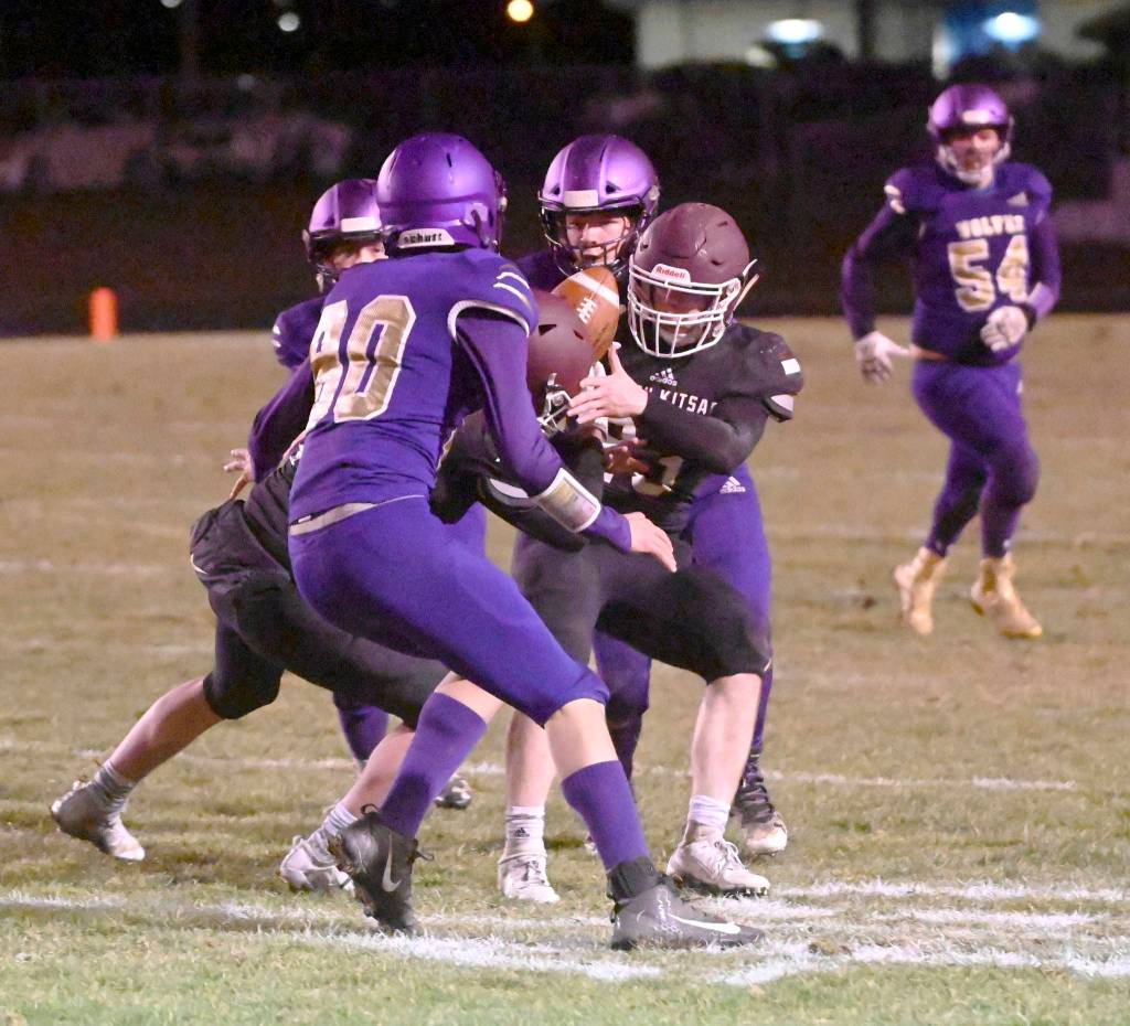 South Kitsap receiver Brayden Segerman tries to get his hands on a pass while surrounded by Sequim defenders. (Michael Dashiell/Sequim Gazette)