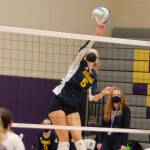 Isabelle Prentice goes up high in the air for Bainbridge to tip a ball over the net. (Mark Krulish/Kitsap News Group)