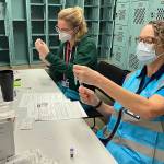 Workers check out the vials.