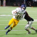 Luke Lavigne tries to evade the grip of a South Kitsap defender. (Mark Krulish/Kitsap News Group)