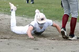 Bainbridges JR Ritchie slides into third during the Spartans 2021 opener Tuesday against Kingston, a 20-0 route. (Mark Krulish/Bainbridge Island Review photos)