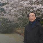 Clarence Moriwaki, with the dock in the background and a cherry tree in blossom in the foreground, talked about the Japanese American concentration camps at the ceremony.