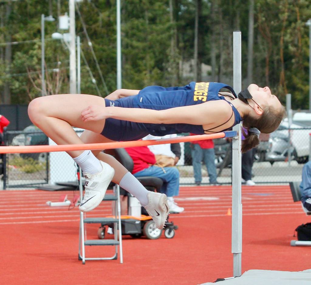 Bainbridge junior Allie Wildsmith clears the bar in the high jump. She placed second in the event. (Mark Krulish/Kitsap News Group)