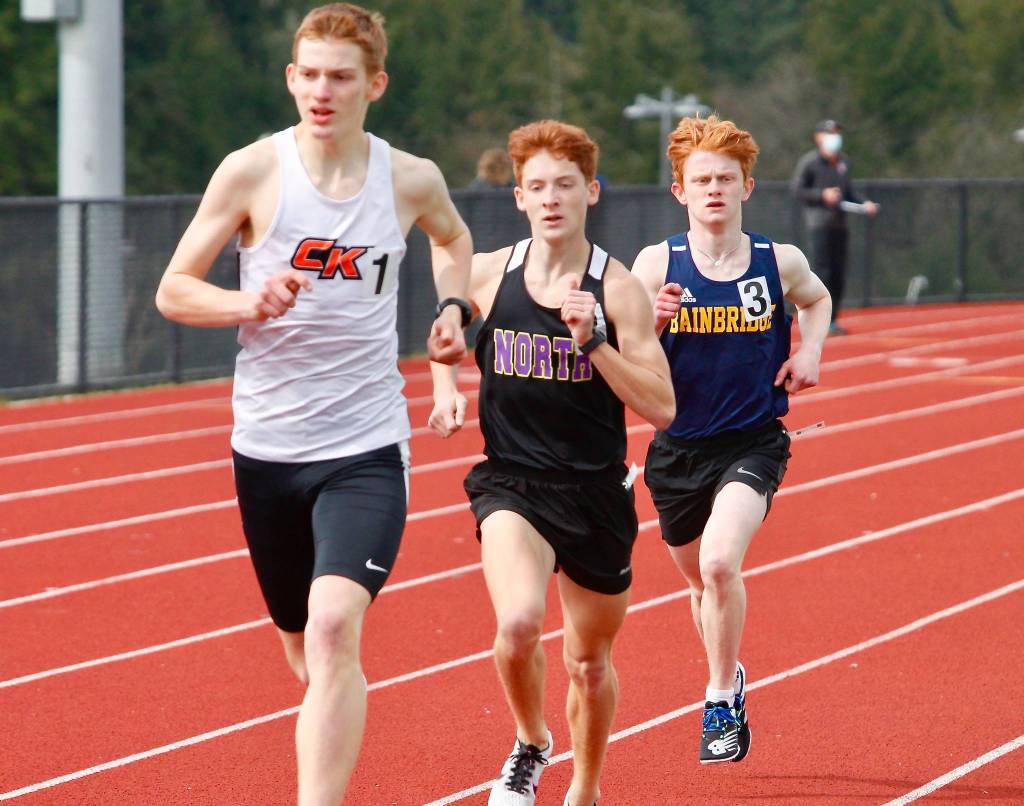 Alec Ibarra of North Kitsap and Alexander Miller of Bainbridge chase Central Kitsaps Daniel Lizon in the 1600-meter run. (Mark Krulish/Kitsap News Group)