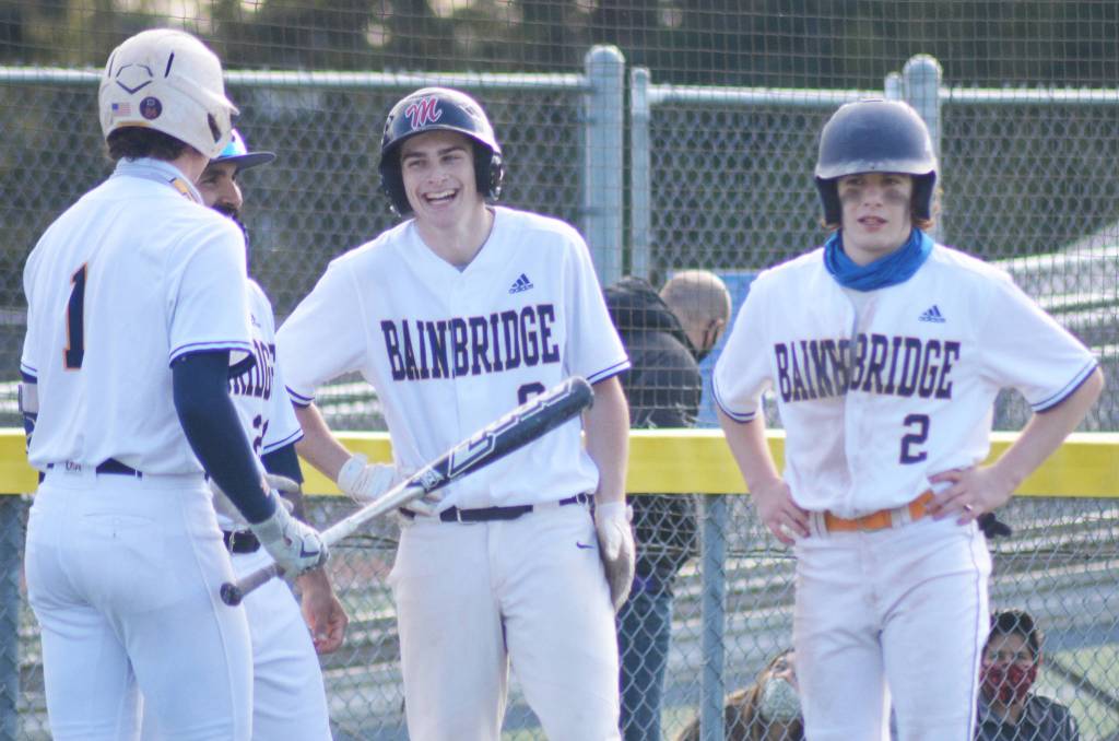 Owen McWilliam is all smiles talking to his teammates and coach during a timeout after swiping a base.