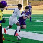Bainbridge forward Damoni Mckenna-Greenawalt looks to break away down the sideline as North Kitsap's Dylan Brindle gives chase. (Mark Krulish/Kitsap News Group)