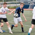 Senior midfielder Aiden Parrish tries to hold off Sequims Ethan Knight for a loose ball. (Mark Krulish/Kitsap News Group)