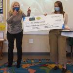 Emily Cornell (right) stands with a representative from STAR 101.5 after winning the honor.