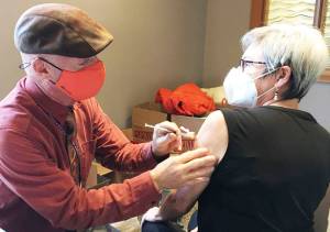 Dr. Fred Hoffer gives a COVID-19 vaccination to wife Donna Rodger. Courtesy Photo
