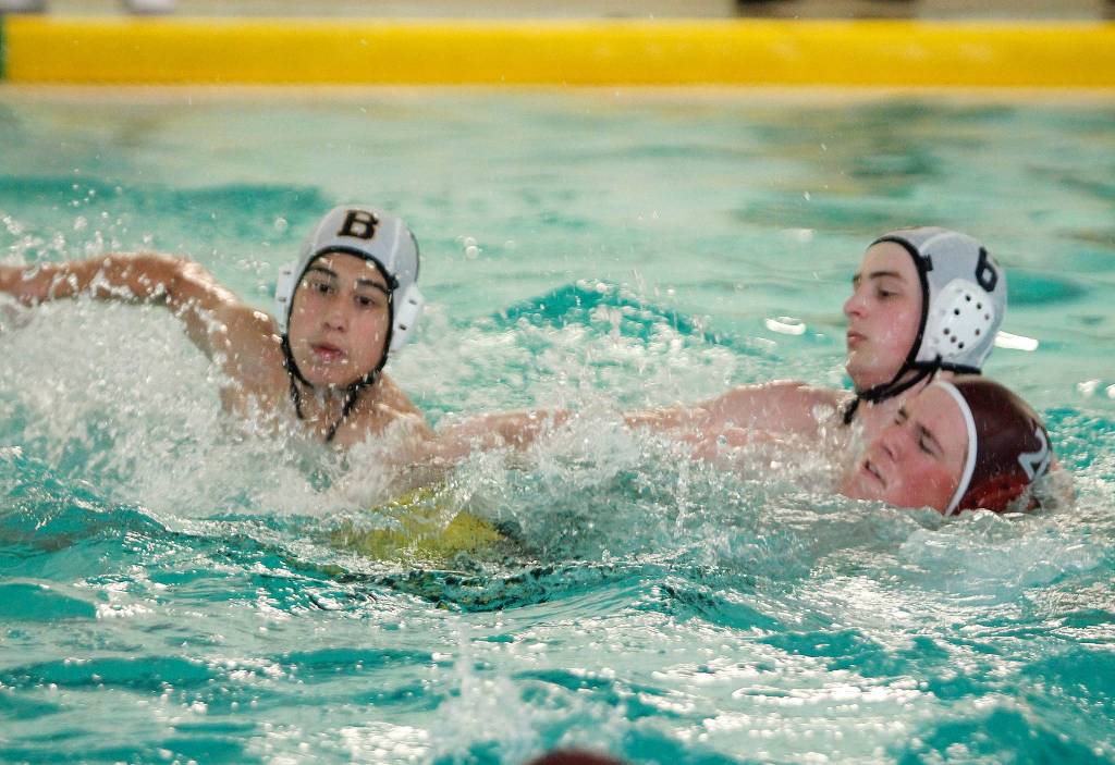 Winston Block (left) races for a loose ball along with Zane Wright (6) and Daulton Lynam (20). (Mark Krulish/Kitsap News Group)